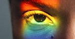 Beauty, rainbow and the eye of woman with a prism light reflection. Creative makeup, gay lifestyle and neon eye cosmetics for lgbt pride. Vision, eyesight and beautiful eyes and eyebrow on black girl