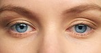 Blue eyes woman, focus and vision in eye care sight, eyelid blink with detail pupil and iris. Portrait closeup of a female in focused healthy eyesight or optometry treatment looking in concentration