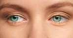 Eyes, vision and happy girl or woman looking at camera while feeling happiness, peace and freedom closeup. Beauty, face with hypnotic green eyes and eyesight of relax person with healthy clear eye