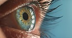 Macro of eye, vision and thinking of future, idea and insight. Closeup zoom of blue or green contact lens, iris and retina with a person looking at a light during during an eye exam at optometrist.