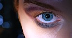 Blue eyes, makeup and glamour cosmetics for beauty and nightlife look. Face zoom portrait of a young person with glitter and shimmer smokey eyeshadow for fashion model show or catwalk with bokeh