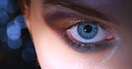 Blue eye, eyeshadow makeup and woman with dilating pupils reaction after drug. Face closeup and zoom into human iris. Eyeball, retina and looking at camera with compelling vision or mydriasis