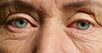 Vision, eye and retirement with the eye of a senior woman with wrinkles looking and blinking closeup. Elderly female at the optometrist or optician for a test or exam for prescription lenses