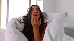 Woman in blanket smile, make silly kiss in the morning in luxury room at hotel or home. Latino girl laugh after hide face with duvet, in bedroom at apartment or hospitality house while on vacation