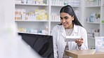 Pharmacist working on computer at a pharmacy with pills to check order online. Woman with technology to access medical database, inventory check and online medicine prescription in a healthcare store