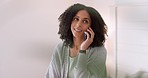 Happy black woman talking on a phone call while relaxing in bed at home, checking her schedule and make plans. Cheerful African American female enjoying time off, planning fun for the weekend