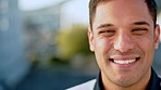 City, happy businessman and face with smile expression against a blurred urban background. Portrait of a young latino male manager or executive in corporate job smiling in success on a break outdoors