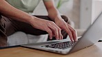 Closeup of freelancer hands typing on a laptop with a remote job working in his living room. Creative man doing research on the internet or planning a freelance project for a company with a computer.