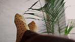 Man feet with fashion and relax socks on the sofa at home moving to music on the weekend in the house living room. Cool, yellow or stylish footwear of a person relaxing, chilling and resting in house