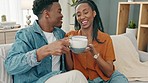 Coffee, relax and black couple on sofa in home living room for weekend relaxing indoor, bonding and talking about day. Social, love and black people on date drinking tea or espresso from cup on couch