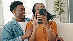 Man and woman, on sofa with phone, on social media, laugh at funny post, or meme in living room. Young African American, couple use smartphone, to see happy images, on the internet while home.