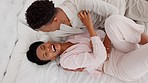 Love, black couple and fun while laughing together in bedroom to relax, tickling and cuddle romantic, intimate and playful affection at home. Above view of man and woman in a happy relationship