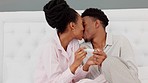 Couple, kiss and smile after pregnancy test result and happy in bedroom at home. Black woman and man read a positive baby results, love and happiness to start family together in a the house bedroom