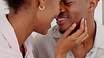 Love, couple and kiss with smile in happy marriage embracing affection and care together at home. Black woman and man in joyful happiness for passionate relationship smiling in touching romance.