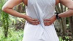 Fitness runner back pain, sport injury stress and hands massage body in outdoor wellness park. Female athlete hurt backache, arthritis spine support and medical first aid training help muscle joint