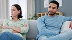 Angry couple fight, annoyed people and frustrated partners fighting about divorce on a living room couch. Sex problems, cheating confession fail and breakup of a man and woman on a house lounge sofa 