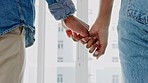 Hand, love and couple with a man and woman holding hands while bonding together in their home. Trust, dating and romance with the fingers of a boyfriend and girlfriend inside their house closeup