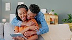 Love, hug and happy couple with tablet relax on home living room sofa with black woman on online shopping store for fashion deal. Wow and girl doing internet web search with surprise embrace from man