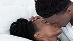 Love, bed and couple with a black woman and man sharing an intimate moment in the bedroom of their home. Romance, affection and happy with a young male and female bonding together in the morning