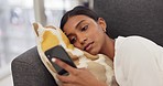 Social media phone, relax woman and reading chat on mobile app on the sofa in home, communication on internet and connection online with smartphone on couch. Young Indian girl on web with tech