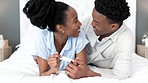 Pregnant couple, fertility and black couple taking a home pregnancy test and happy with a positive results while sharing a kiss and love. Excited black man and woman celebrating good news in bedroom