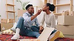 Black couple eat pizza in new house or property while talking after moving in with boxes in the living room. ma and woman love, food and bonding in lounge or real estate, apartment or flat together