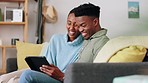 Couple, digital tablet and sofa with happy, man and woman streaming, laugh, bond and watch online movie. Smile, relax and internet entertainment with African American husband and wife having fun 