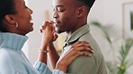 Young black couple dancing, home fun in apartment living room and celebrate honeymoon together. Laughing happy african woman, smile of black man and celebrate love with slow dance holding hands
