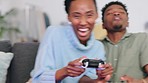 Crazy couple play video game and having fun, gaming online together at home. Funny black man and woman holding joystick controllers relax and enjoying their free leisure break time on the sofa
