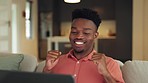 Happy, excited and a black man with laptop on sofa, celebration email news. Happy student gets loan or approval from university application. Success online, celebrate and a winner in the living room.