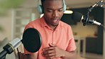 Podcast black man writing music idea in notebook and talking on microphone and headphones in home studio. Radio gen z influencer or artist planning production audio content creation for social media