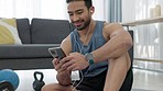Home fitness, phone or music app for man in workout, training or wellness exercise on house living room floor. Happy smile or health goal motivation asian and gym earphone in interior lockdown sports