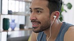 Tired, healthy and fit man after exercise with earphones to listen to music, podcast or radio for a happy workout or training at home. Fitness male, wellness and exercising for a positive mindset