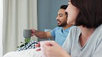 Couple, morning and coffee in bed laughing together talking while sharing a funny joke at home. Man and woman in relationship share laugh and drink in joyful, cheerful and comedy humor in the bedroom
