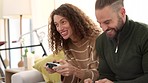 Gaming, couple and video games with a woman and man playing an online game while being competitive in their home. Smile, control and console with a happy male and female gamer enjoying having fun