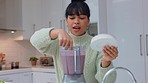 Woman tasting healthy smoothie in blender for fruits detox, weight loss and gut health diet in home kitchen. Happy young vegan female lick fingers of breakfast drink for protein, energy and wellness