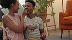 Couple kiss, happy lunch and communication with food in home living room, relax with nutrition salad and conversation on floor with breakfast. African man and woman kissing while eating healthy