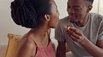 Couple kiss, eating breakfast and happy with food for nutrition, smile for fruit in the morning and celebration of love in home. African man and woman kissing with health diet in the bedroom 