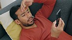 Glitch, mistake and man texting on sofa, shocked by bad news, scam alert or a breakup text. Confused, unhappy and worry with young male surprised by app message, feeling puzzled and nervous in home