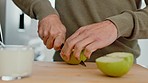 Apple, hand and food with the hands of a man cutting fruit in the kitchen of his home for health, diet and nutrition. Nutritionist, healthy and salad with a male chopping fruits in his house
