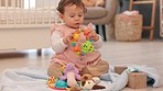 Baby, home and sensory toys experience of a child learning knowledge growth and motor skills. Little girl at a house touching, playing and chewing a colorful, fun and kids educational toy in a room