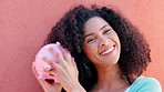 Piggy bank, cash and savings with a black woman listening to money in a pig outside on a pink wall background. Happy, smile and success with a young female confident with her finance and budget