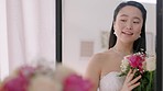 Wedding, bouquet and asian bride in the mirror with flowers or roses for beauty, cosmetics or makeup. Young Japanese woman check beautiful reflection with happy smile for marriage, luxury or fashion