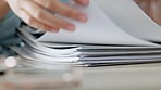 Zoom of woman hands, organise paper or search for document in paperwork stack on table at work. Lady use fingers to find report, information on pages or file on desk while working in closeup portrait