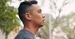 Man doing exercise, stretching and running in the morning at the park. Young mixed race male doing a pre workout stretch and put his arms behind his head. Fitness, stress relief and training runner
