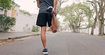 Motivation, fitness runner or man stretching legs in street for running, training or workout for marathon race. Health, wellness and athlete with focus or power to start outdoor cardio sport exercise