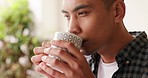 Calm, nature and man with a cup of coffee sitting in an outdoor garden at his modern house. Thinking, relax and pensive guy enjoying warm tea in his natural backyard outside for peace.