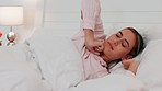 Morning, bed and sleeping woman wake up feeling relax, free and peace after relaxing, dream or rest in home bedroom. Yawn, happiness and calm girl waking up from wellness beauty sleep for mind health