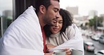 Cold couple, blanket and drinking coffee outdoors on balcony of house for love, warmth and romantic cuddle. Young man, happy woman and hug in winter time for care, relax and hot tea beverage together