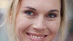 Portrait of middle aged woman with a smile on her face looking happy. Close up of elderly female with natural beauty, perfect skin and blue eyes smiling. Inspiration, happiness and wellness in beauty